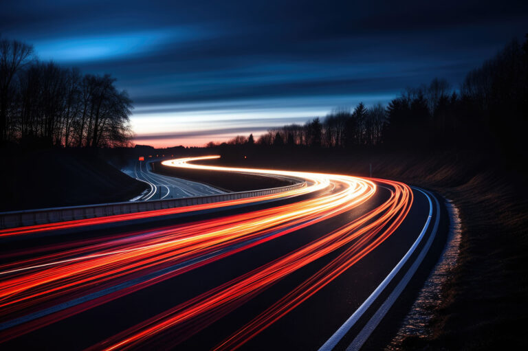 Long exposure image of a highway at dusk showcasing vibrant streaks of car lights amidst a darkening sky symbolizing digital transformation