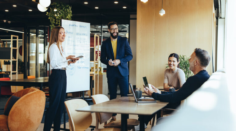 Cheerful businesspeople discussing marketing strategies in a modern workspace during a collaborative team meeting