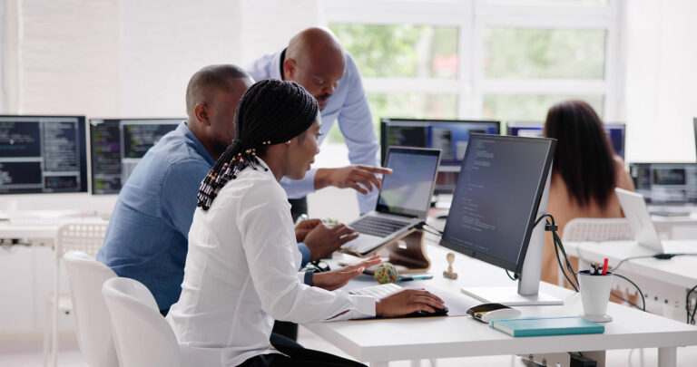 African business team collaborating on software app development in a modern office focused on coding and technology solutions