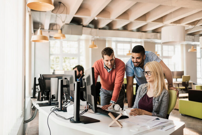 Young professionals collaborating on a project in a modern startup office showcasing teamwork and creative problem solving