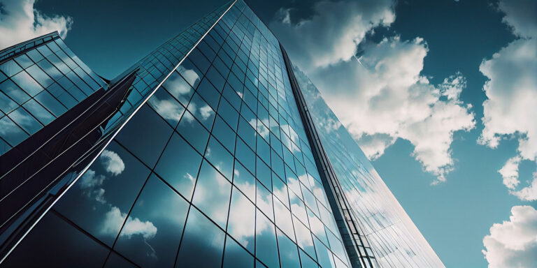 Reflective skyscrapers under a blue sky illustrating urban architecture related to Azure cloud migration