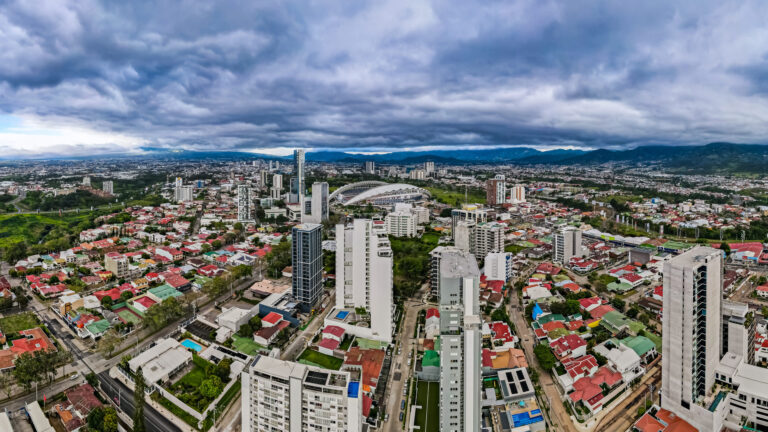 A panoramic view of a vibrant urban landscape with diverse architecture under a dramatic sky showcasing the citys dynamic character