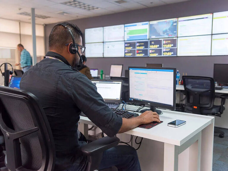 Call center environment in Costa Rica showcasing an employee working on computers with multiple monitors emphasizing nearshoring advantages