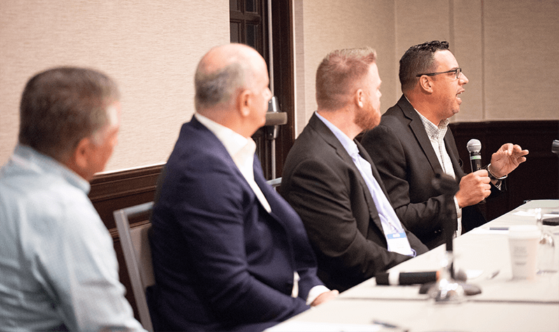 Panel discussion featuring multiple speakers engaging in a CIO Breakfast Roundtable on maximizing cloud value