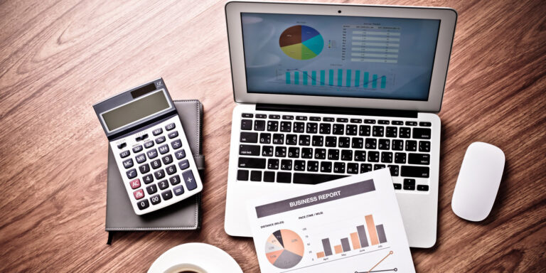 A financial report displayed on a laptop with charts and graphs