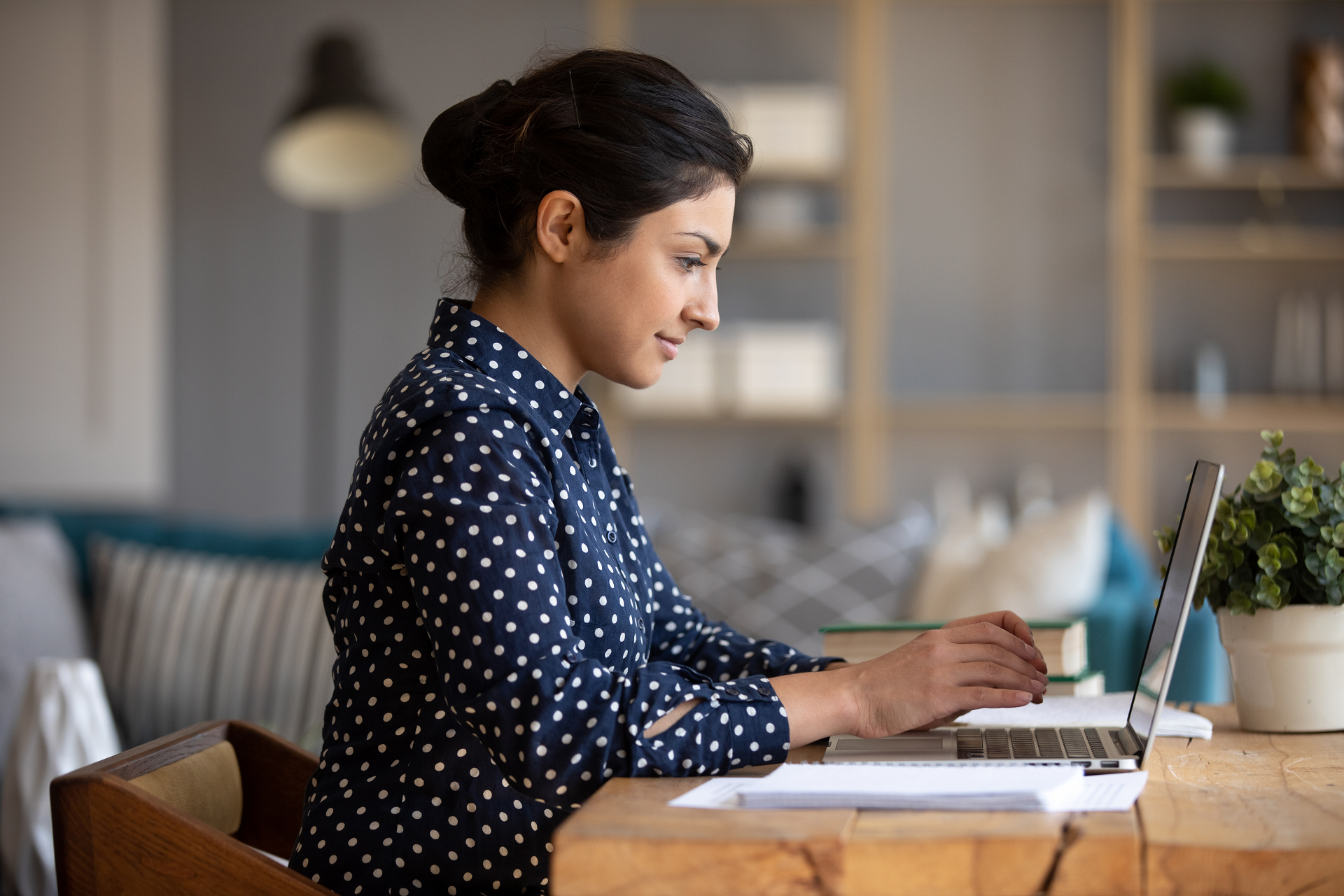 Focused professional working remotely on a laptop in a home office environment