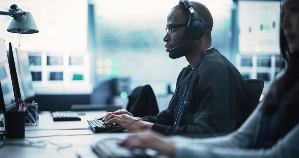 Man with headset working in computer