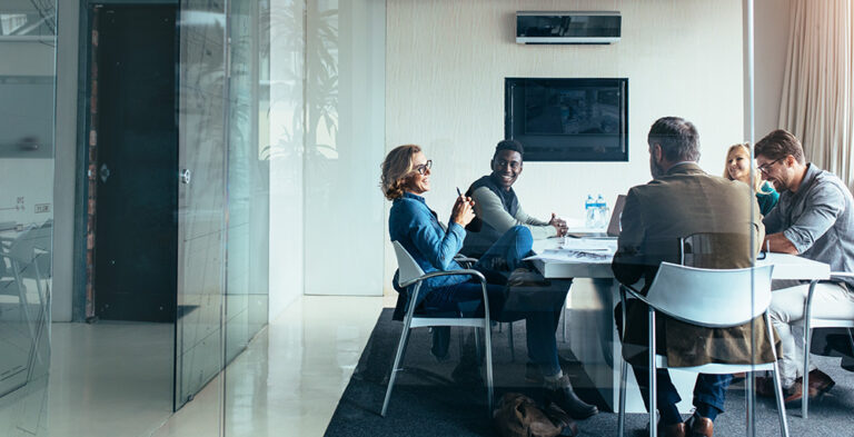 Business team engaged in discussion during a meeting promoting effective collaboration in a hybrid work environment