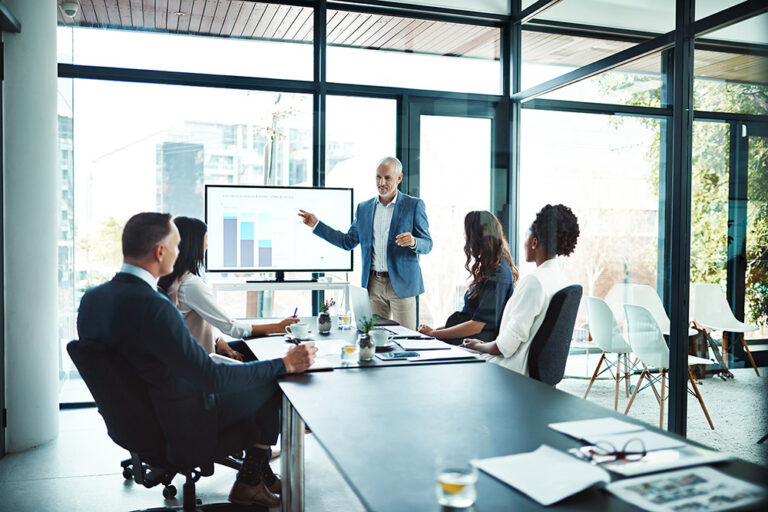 Business meeting with a male leader presenting charts in a modern office discussing project efficiency and teamwork