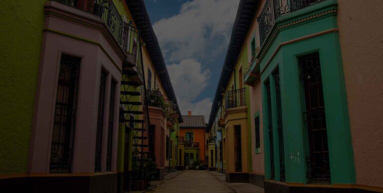 Colorful buildings lining a narrow street showcasing vibrant architecture typical of Latin American towns