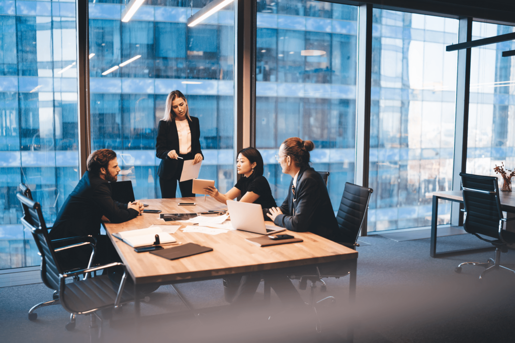 Group of people meeting in an office discussing business decisions