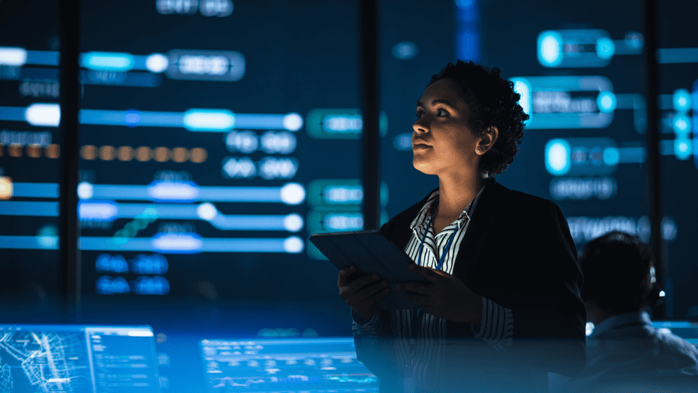 Woman engaging with multiple screens and tablet AI driven automation