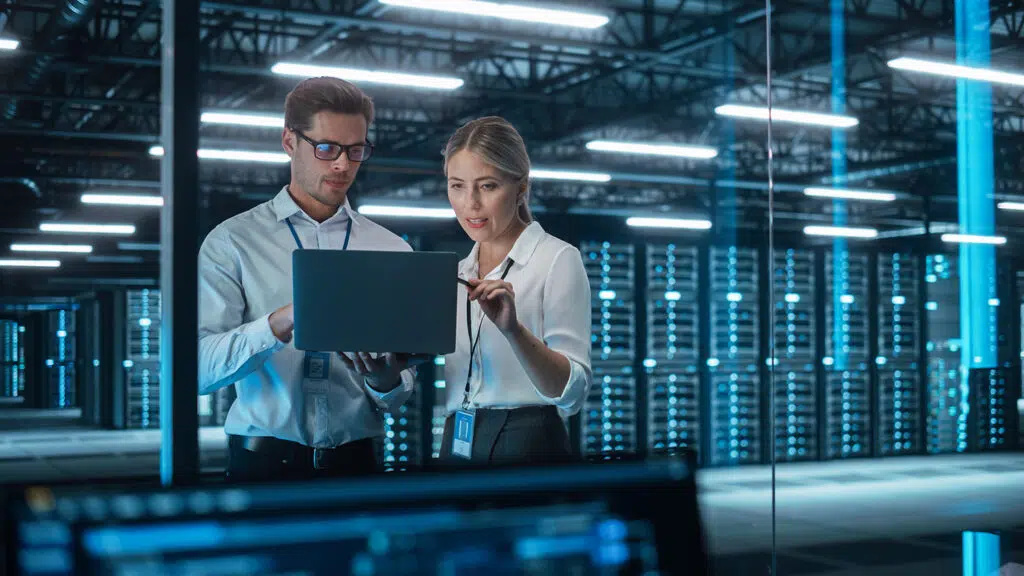 Male CEO Discusses Problem Solving with Female Partner in Office - Auxis Male CEO Discusses Problem Solving with Female Partner in Office