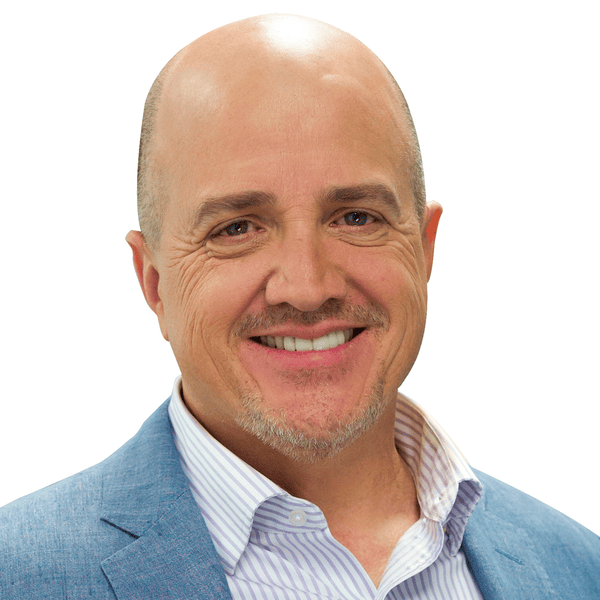 Smiling professional man in a blue jacket, representing confidence and approachability in a business context.