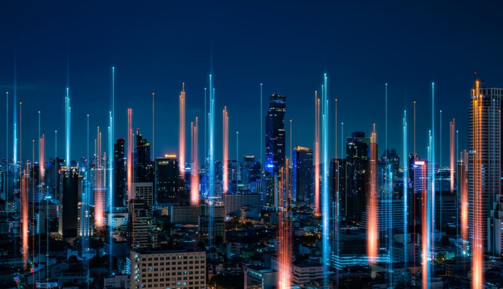 Vibrant city skyline at night with illuminated skyscrapers and abstract light trails representing digital connectivity