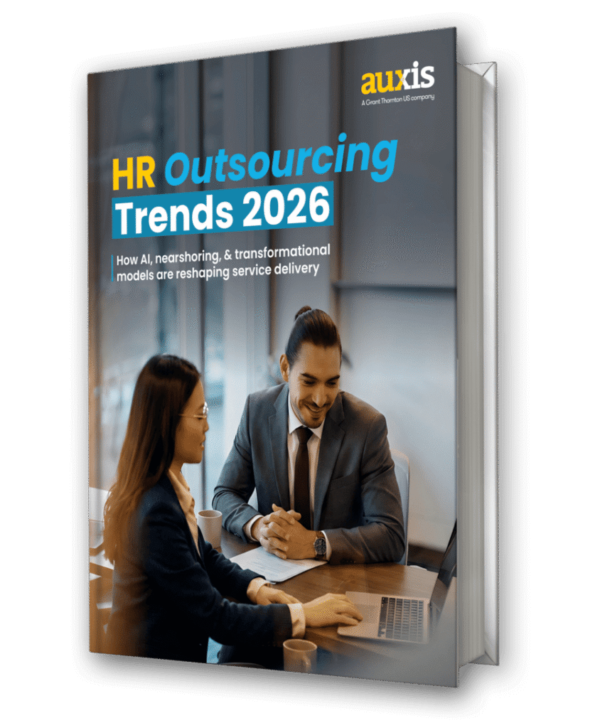 HR outsourcing trends for 2026 highlighted in a professional setting with two colleagues discussing strategies over a laptop