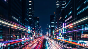 Vibrant cityscape at night showcasing dynamic traffic and illuminated buildings reflecting the pulse of urban finance