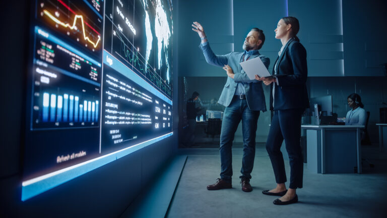 Cybersecurity professionals analyzing AI trends in a control room