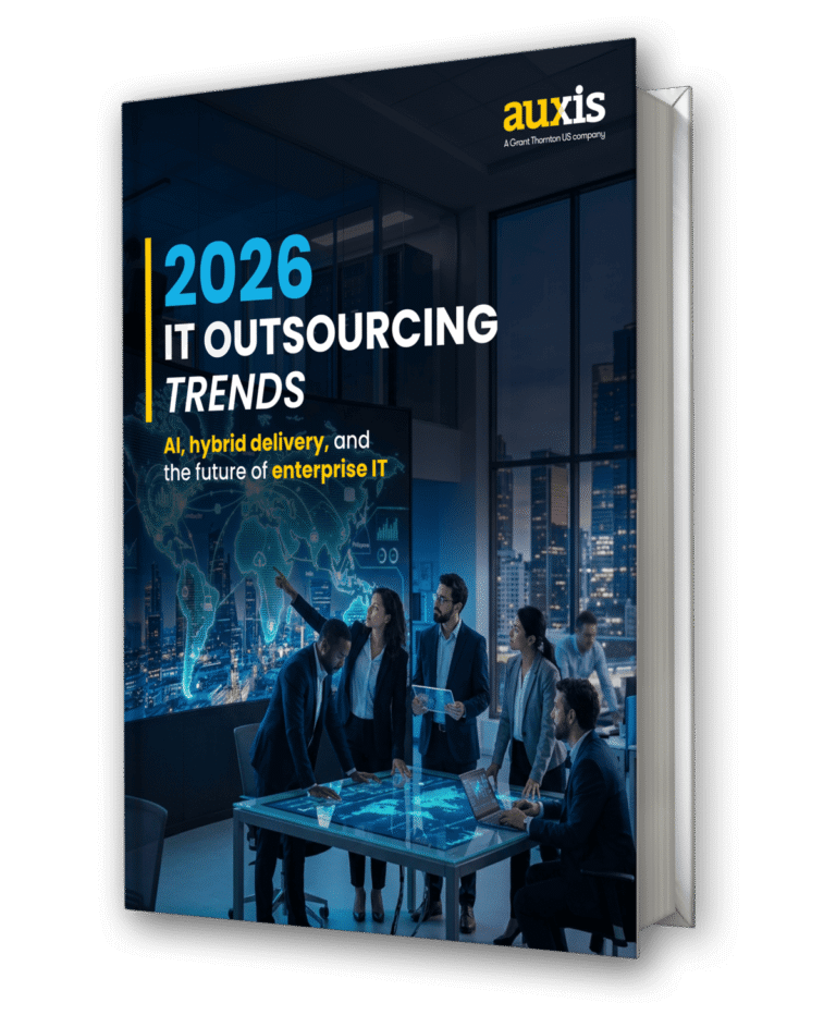 Business professionals discuss 2026 IT outsourcing trends in a modern office highlighting AI and hybrid delivery solutions