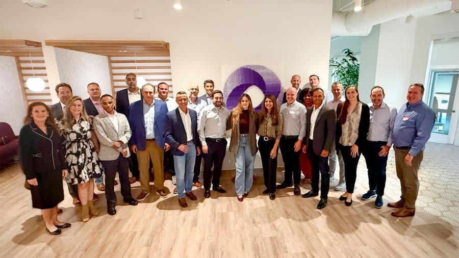Group of professionals gathered in a modern office space showcasing collaboration and networking in a vibrant environment