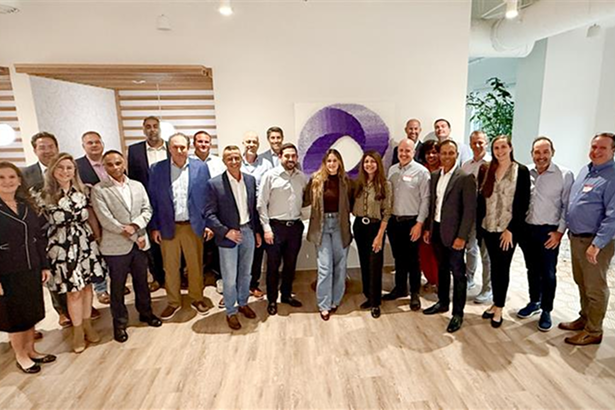 Professionals gathered for a networking event showcasing collaboration and diversity in a modern office setting