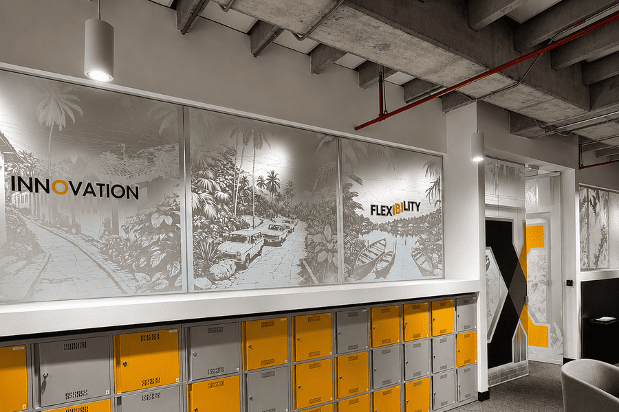 Modern office space featuring yellow and gray lockers, emphasizing innovation and flexibility with artistic wall graphics.
