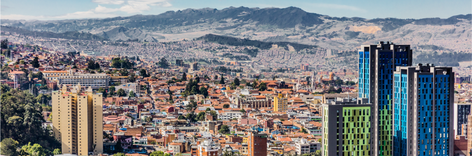 BOG-image-without-borders - Auxis Vibrant cityscape of a Colombian city with modern buildings and mountains in the background highlighting nearshore opportunities