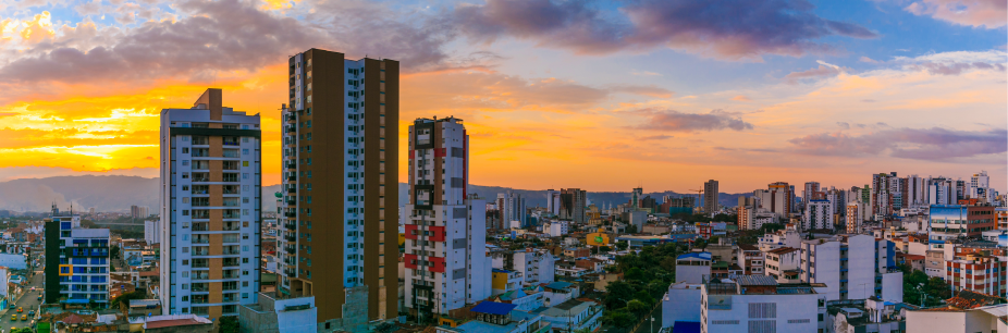 BUC - Auxis Vibrant sunset over a modern Colombian cityscape showcasing high rise buildings and urban life in a nearshore setting