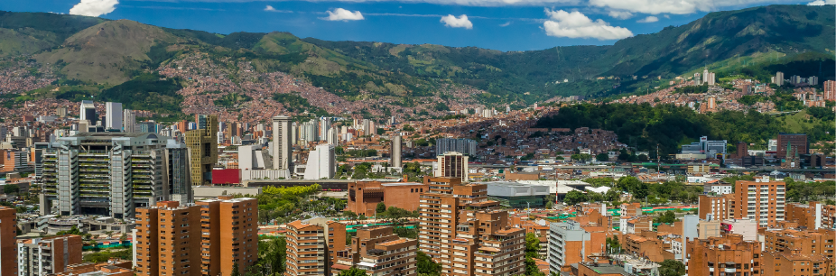 MED - Auxis Vibrant cityscape of Medellín Colombia showcasing modern buildings against lush mountains ideal for nearshore opportunities