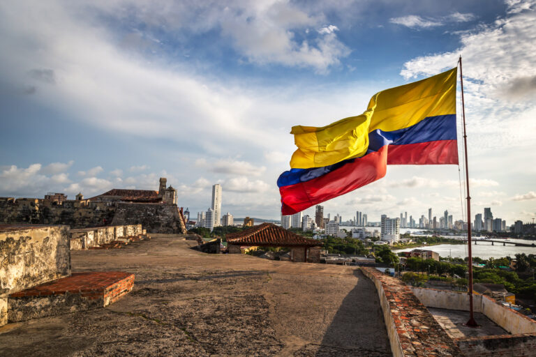 Vibrant Colombian flag waves over Cartagenas skyline showcasing the citys blend of history and modernity