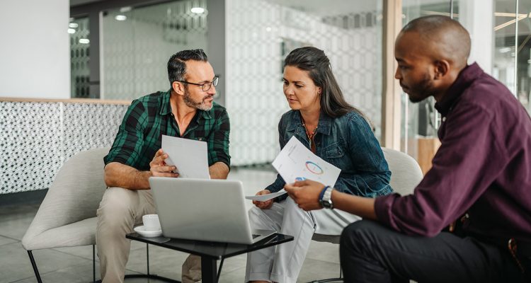 Casual meeting of diverse business team analyzing financial data