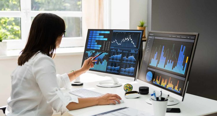 Analyst Women Looking At KPI Data On Computer Screen