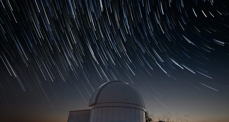 Astronomical observatory under star trails sky at night. High quality photo