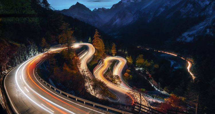 The winding mountain road at the night with light tracks from cars, Maloja Pass, Switzerland