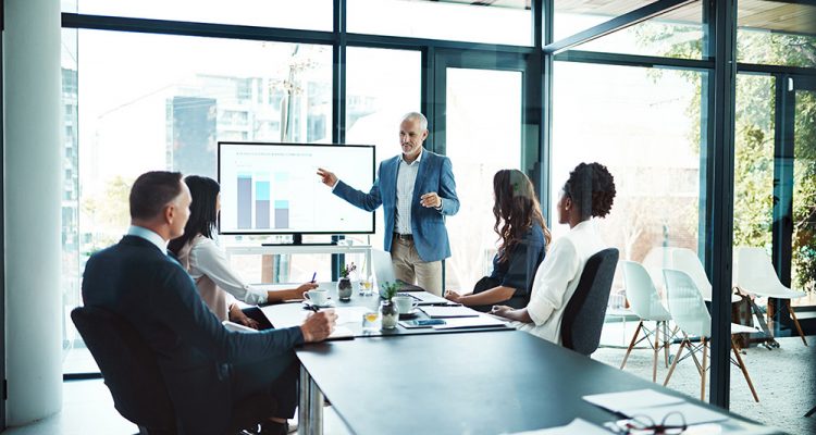 Business, charts and man with presentation, office and conversation for project, profit growth and meeting. Male leader, staff or group with teamwork, graphs or partnership in a boardroom or planning.