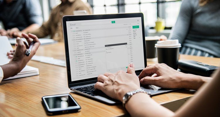 Woman checking her email in a meeting