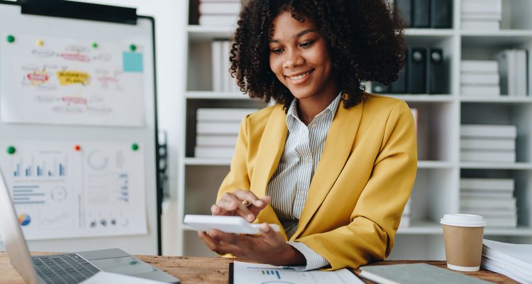 Young asian female work with financial papers at home count on calculator before paying taxes receipts online, planning budget glad to find chance for economy saving money, audit concepts