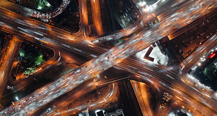 Top-down view of fast-moving cars on a highway, intense traffic