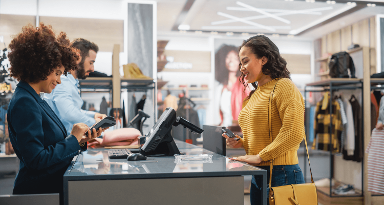 Retail store with staff assisting customers, focusing on IT infrastructure